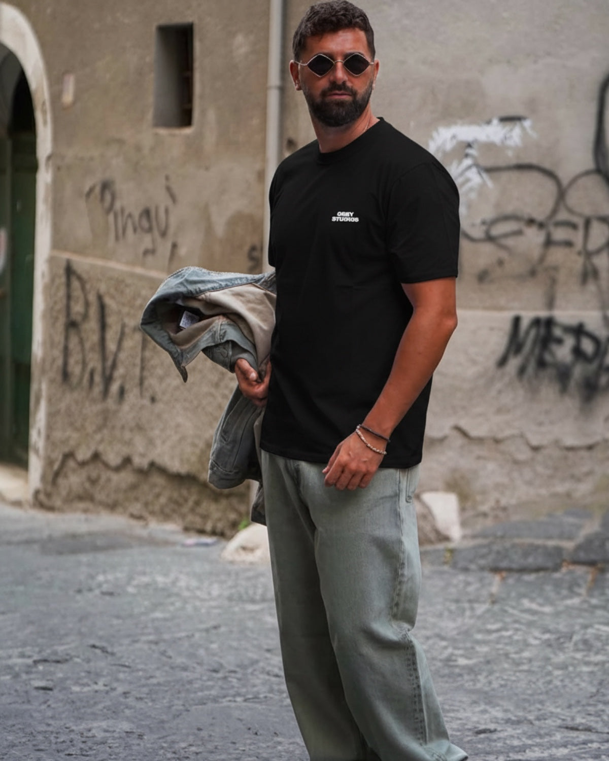Manuel Store black heavyweight cotton t-shirt with OBEY STUDIOS graphic on front and back, relaxed fit.