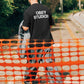 Manuel Store black heavyweight 100% cotton t-shirt with "OBEY STUDIOS" graphic print on back.