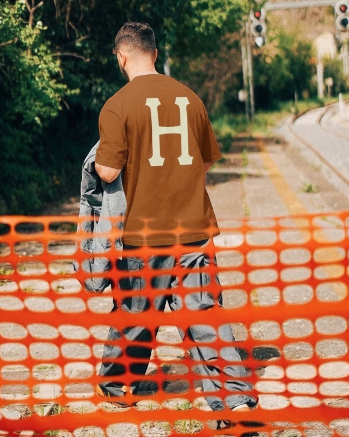 Manuel Store brown 100% cotton t-shirt with large cream 'H' logo on back. Short sleeves, crew neck.