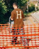 Manuel Store brown 100% cotton t-shirt with large cream 'H' logo on back. Short sleeves, crew neck.