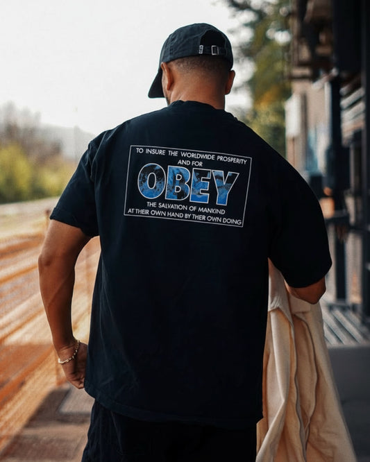 Manuel Store dark grey 100% cotton t-shirt with 'OBEY' graphic print on back.