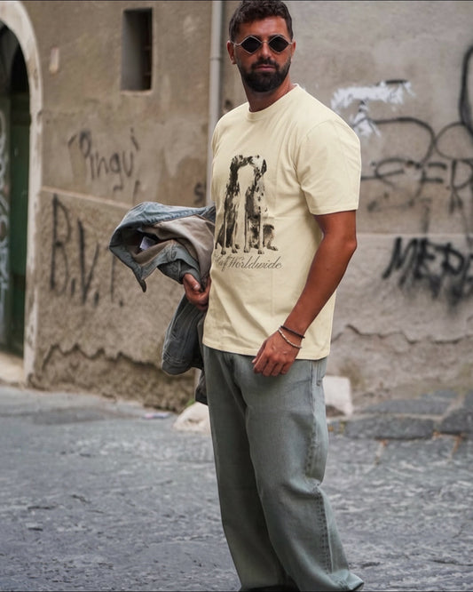 Manuel Store beige 100% cotton t-shirt with two Dalmatians kissing graphic and "HUF Worldwide" text.