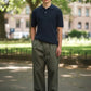 Manuel Store navy blue cable-knit short-sleeve polo shirt with button placket and textured pattern.