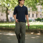 Manuel Store navy blue cable-knit short-sleeve polo shirt on a man walking outdoors.
