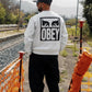 Manuel Store OBEY EYES ICON II CREWNECK sweatshirt in light grey, 80% cotton, 20% polyester, with printed graphic on front and back.