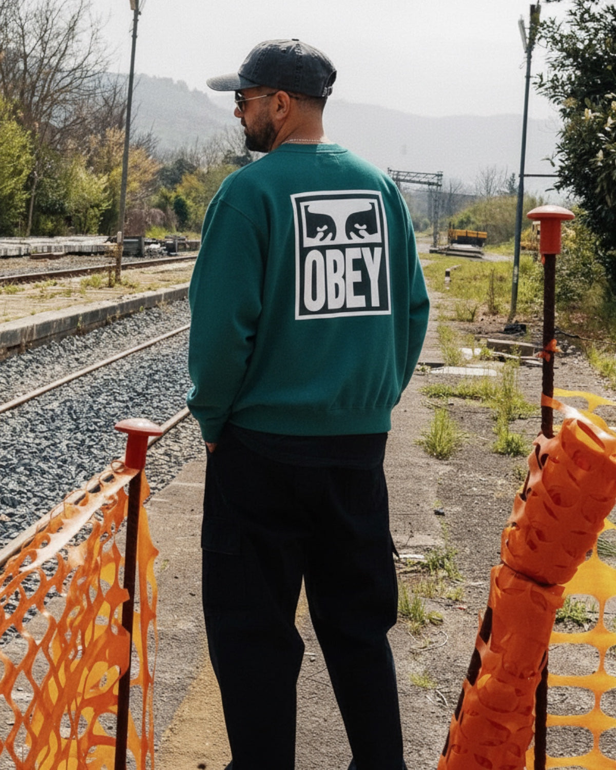 Manuel Store OBEY EYES ICON II CREWNECK sweatshirt in teal cotton blend with printed graphic on front and back.