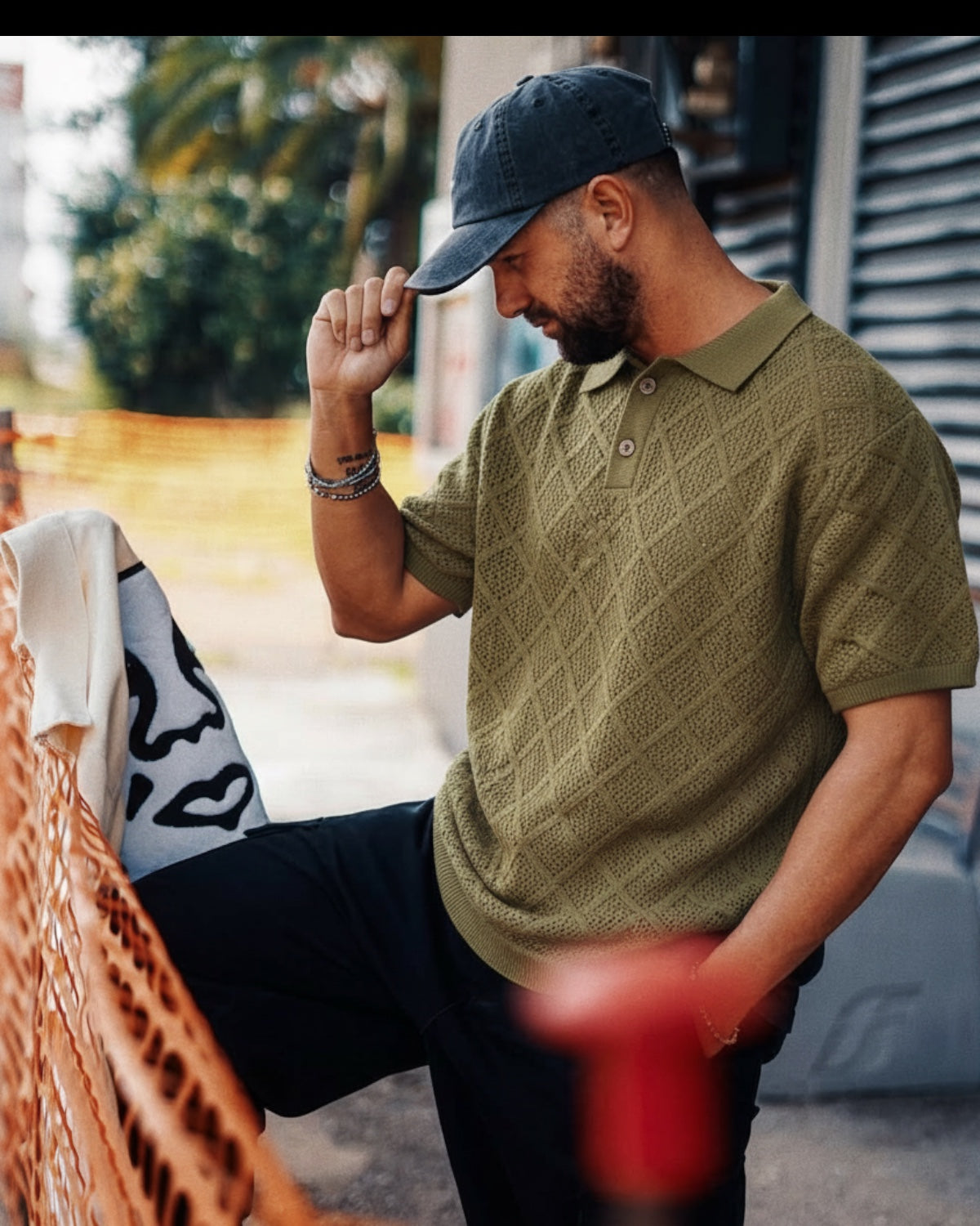 Manuel Store olive green 100% cotton short-sleeve knit polo with diamond pattern and ribbed collar, cuffs, and hem.