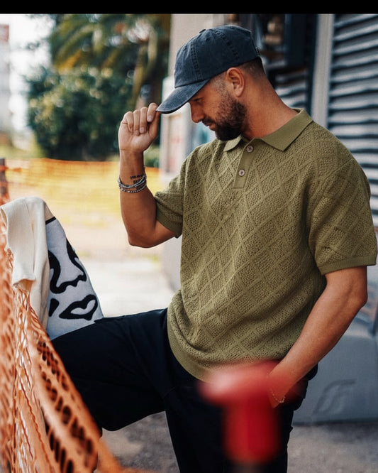 Manuel Store olive green 100% cotton short-sleeve knit polo with diamond pattern and ribbed collar, cuffs, and hem.