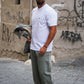 Manuel Store white 100% cotton t-shirt with short sleeves, ribbed crew neck, and embroidered OBEY logo on chest.