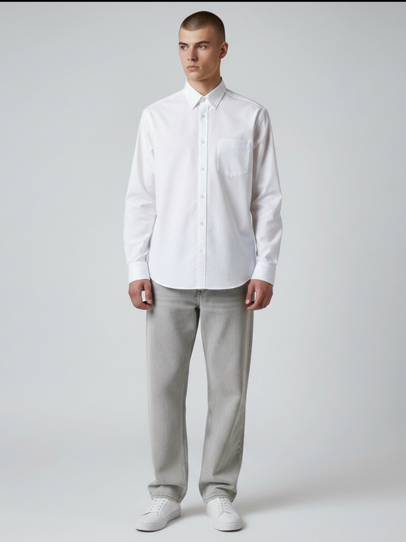 Manuel Store white cotton Oxford shirt with button-down collar, chest pocket, and button cuffs. Relaxed fit.