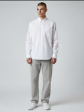 Manuel Store white cotton Oxford shirt with button-down collar, chest pocket, and button cuffs. Relaxed fit.