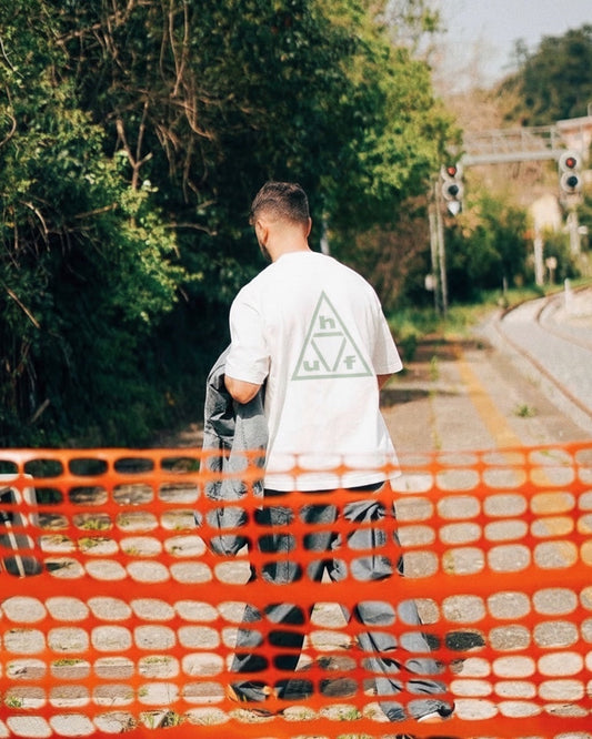 Manuel Store white 100% cotton t-shirt with a light green triple triangle HUF graphic on the back.