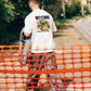 Manuel Store white 100% cotton t-shirt with colorful handprint graphic and "OBEY STUDIOS CREATIVE SERVICES DEPT." text.