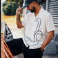 Manuel Store white short-sleeve cotton-linen blend shirt with black swan graphic print and button closure.
